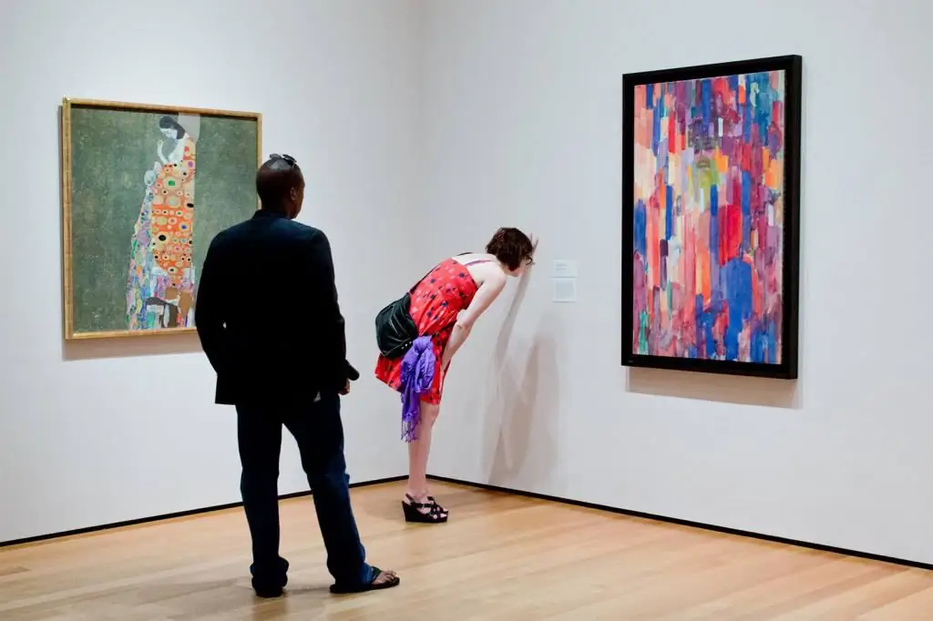 People looking at modern paintings